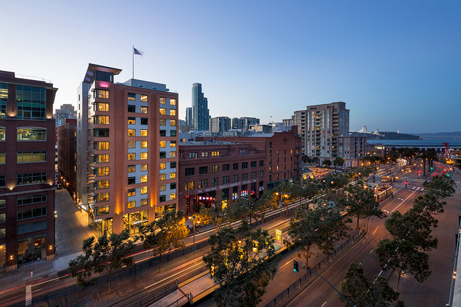 An aerial view of a city at dusk, showcasing the stunning skyline and vibrant lights of a metropolis.