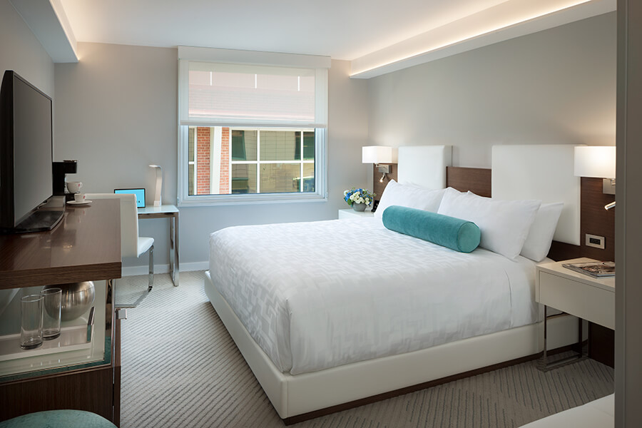 A hotel room near Oracle Park and Chase Center with a bed and a desk.
