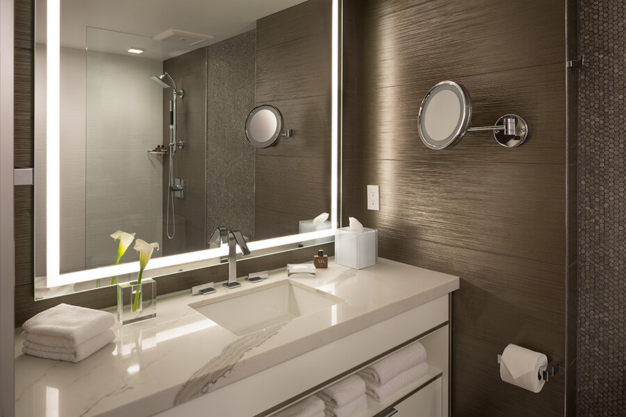 A boutique hotel bathroom in San Francisco, near Chase Center, equipped with a sink and mirror.