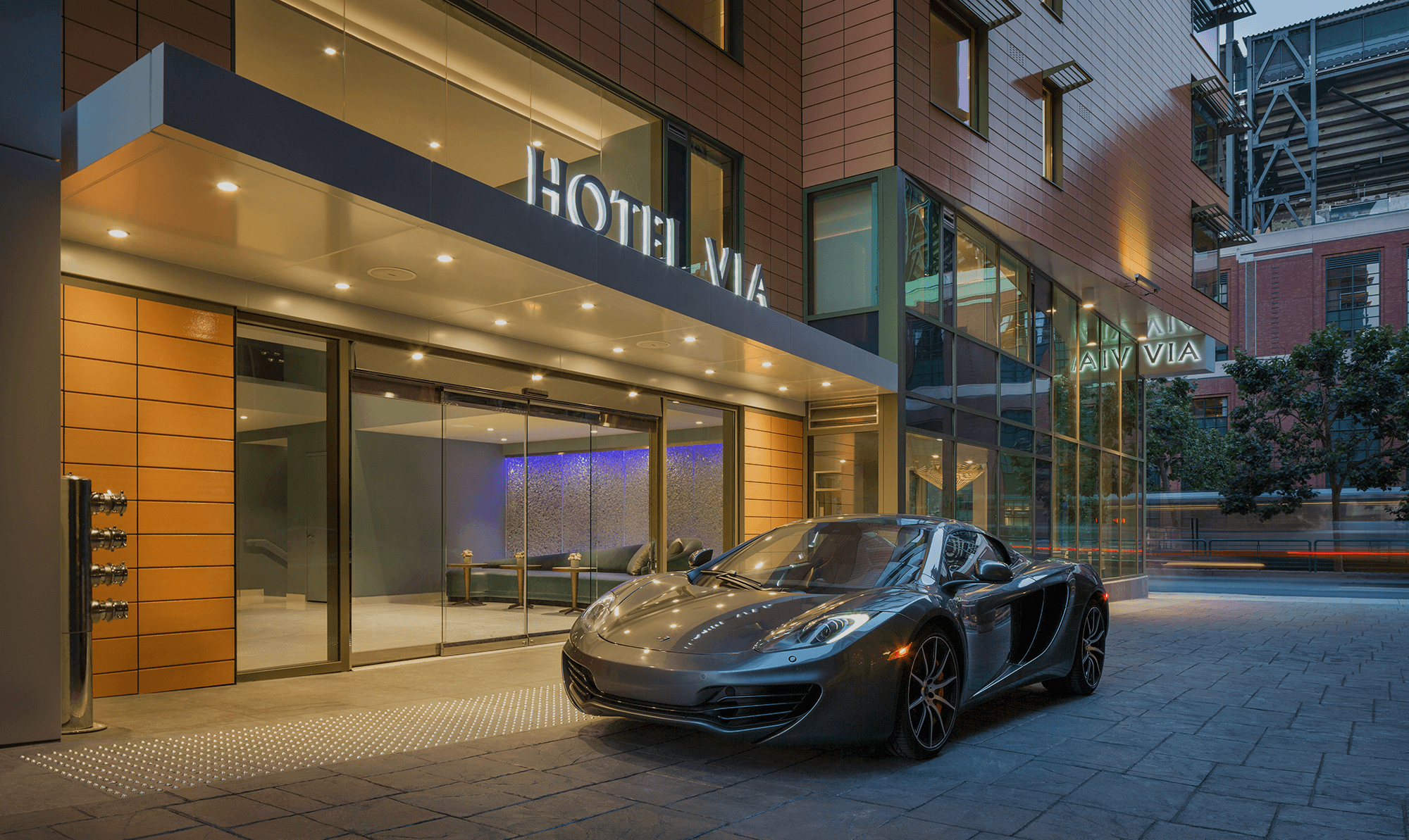 A sports car parked in front of a hotel near Chase Center.