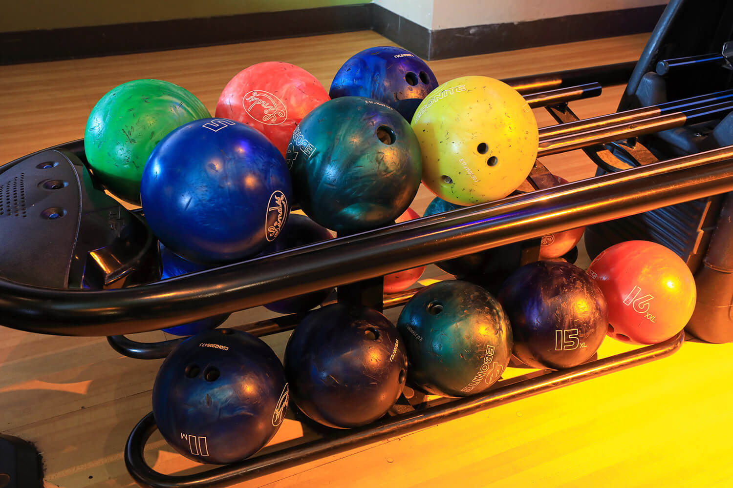 Bowling balls on a rack in a bowling alley located in a South Beach San Francisco hotel.