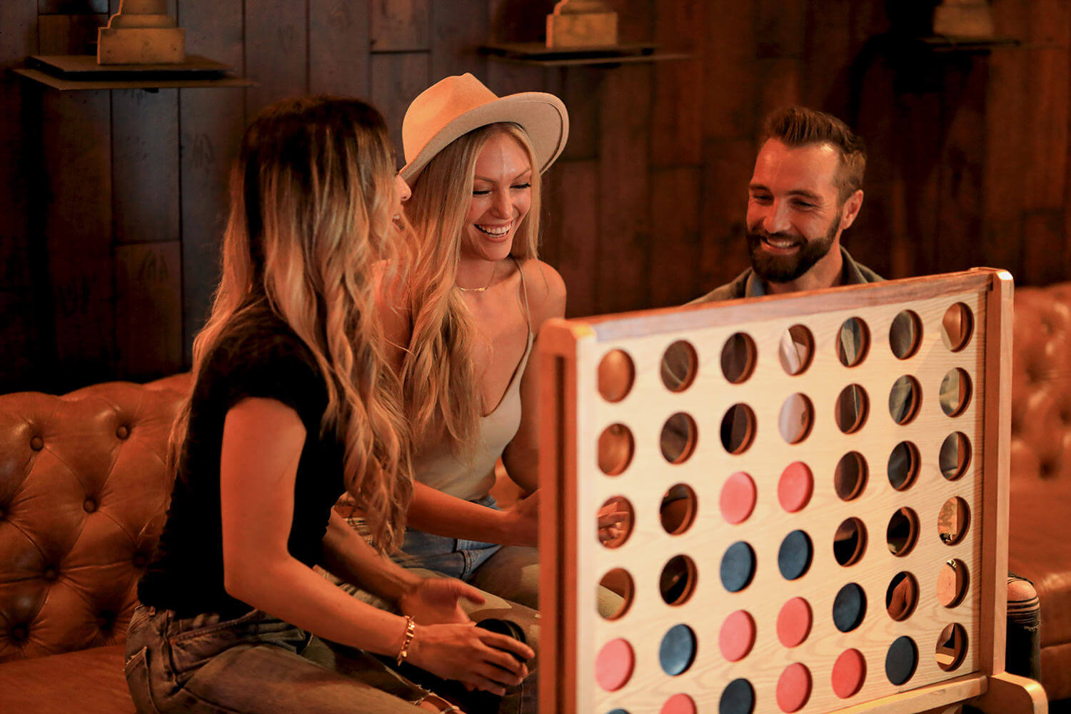 A group of people playing a game of four in a row at a botique hotel near Chase Center.