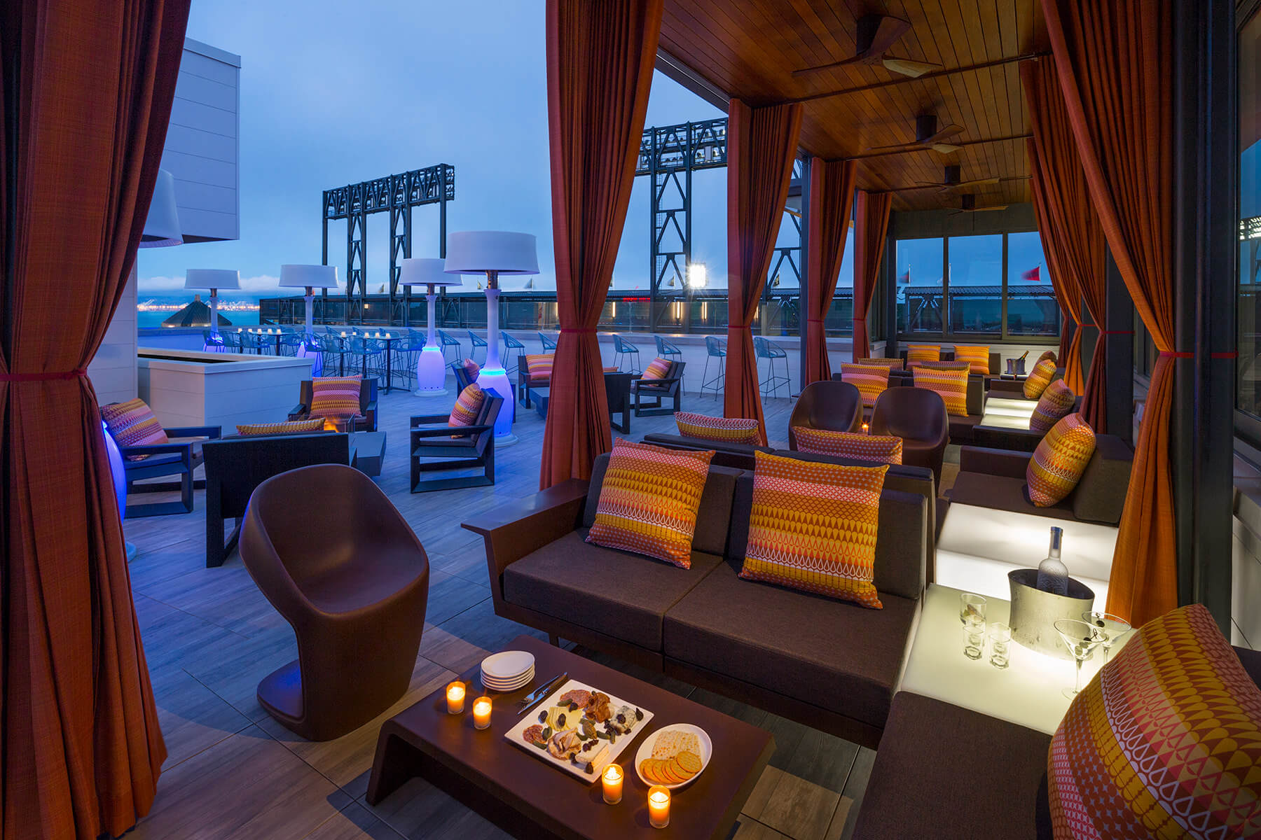 A south beach San Francisco hotel patio with couches and a fireplace.