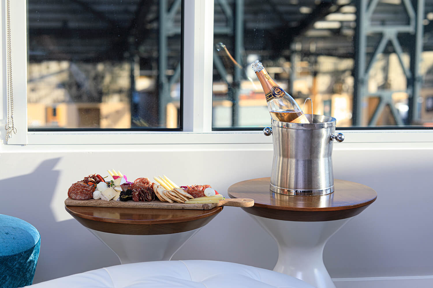 A botique hotel near Chase Center in San Francisco, South Beach, features a table with a bottle of wine on it next to a window.