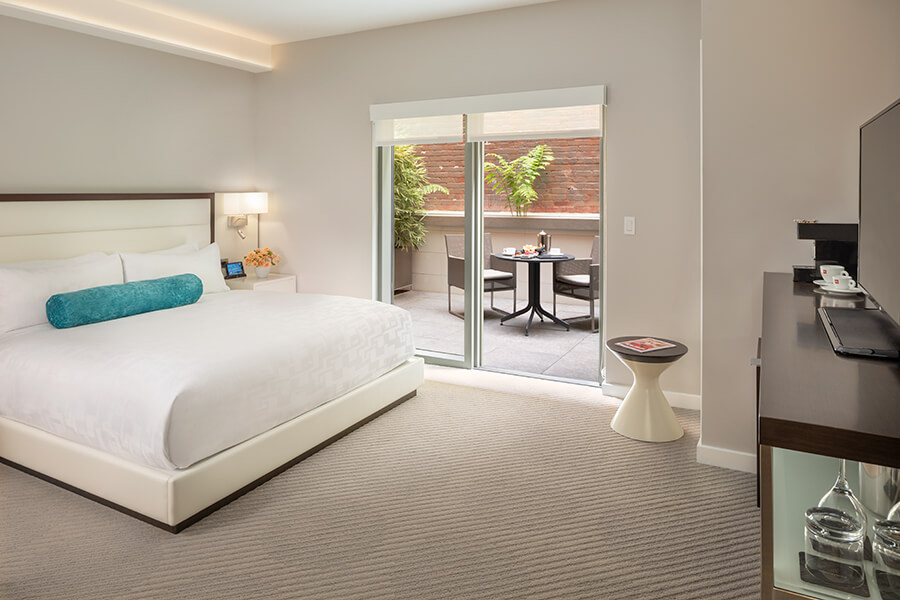         A boutique hotel near Chase Center in San Francisco's South Beach neighborhood, offering a comfortable hotel room with a balcony and a bed.