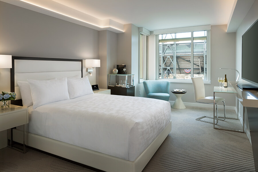 A botique hotel near Chase Center in San Francisco featuring a hotel room with a bed and a desk.